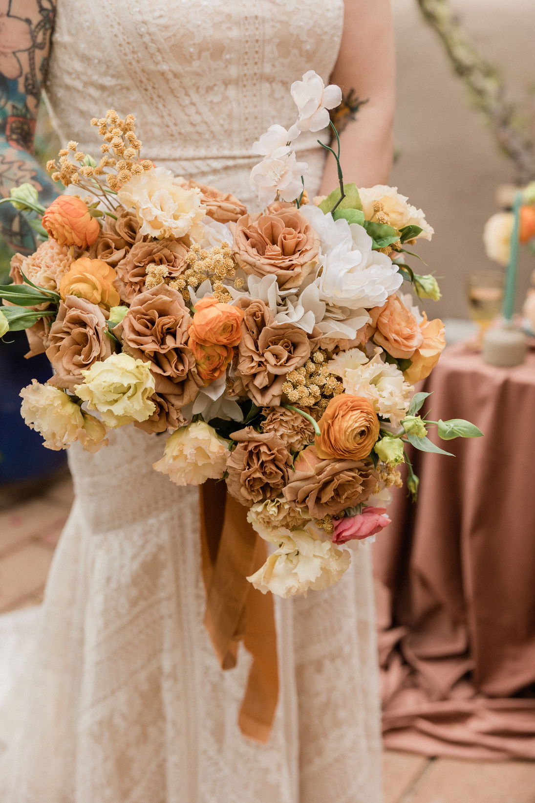 Bride in Wedding Dress Holding Neutral Floral Bouquet